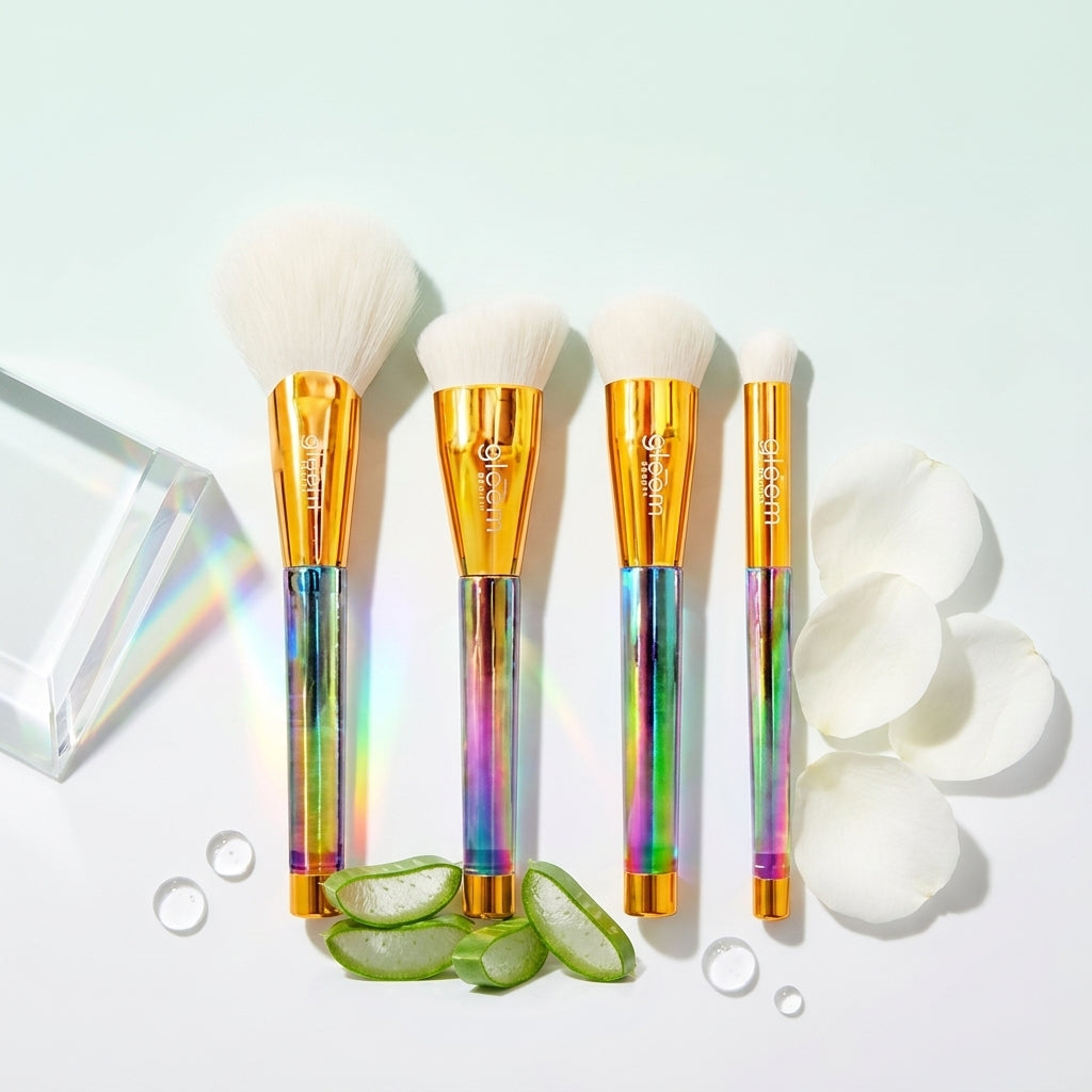 Set of makeup brushes with rainbow handles on a light blue background