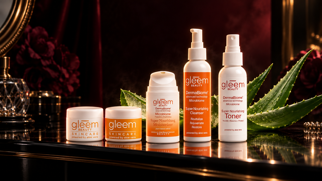 Five Gleem Beauty aloe-based skincare products on a dramatic black vanity with burgundy lighting and aloe leaves