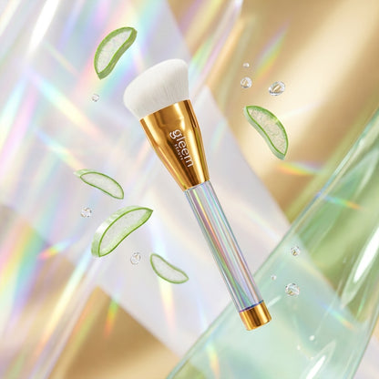 Makeup brush with gold and clear design on a colorful, abstract background