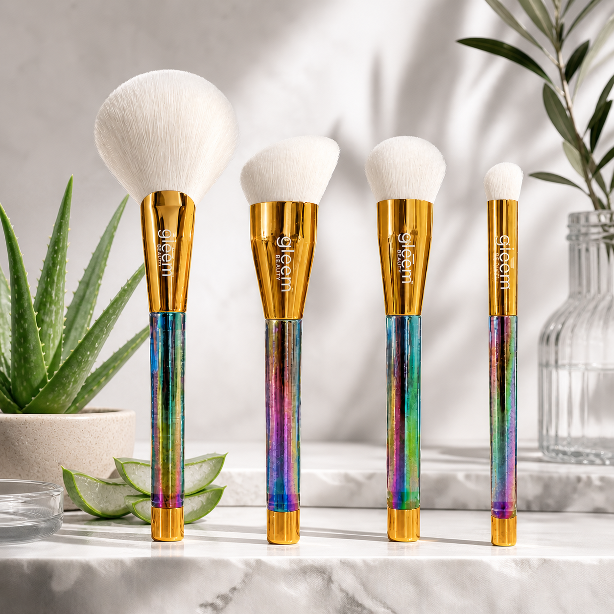 Set of makeup brushes with rainbow handles on a marble surface with plants in the background