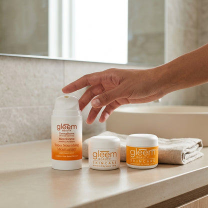 Person reaching for gleem skincare products on a bathroom counter