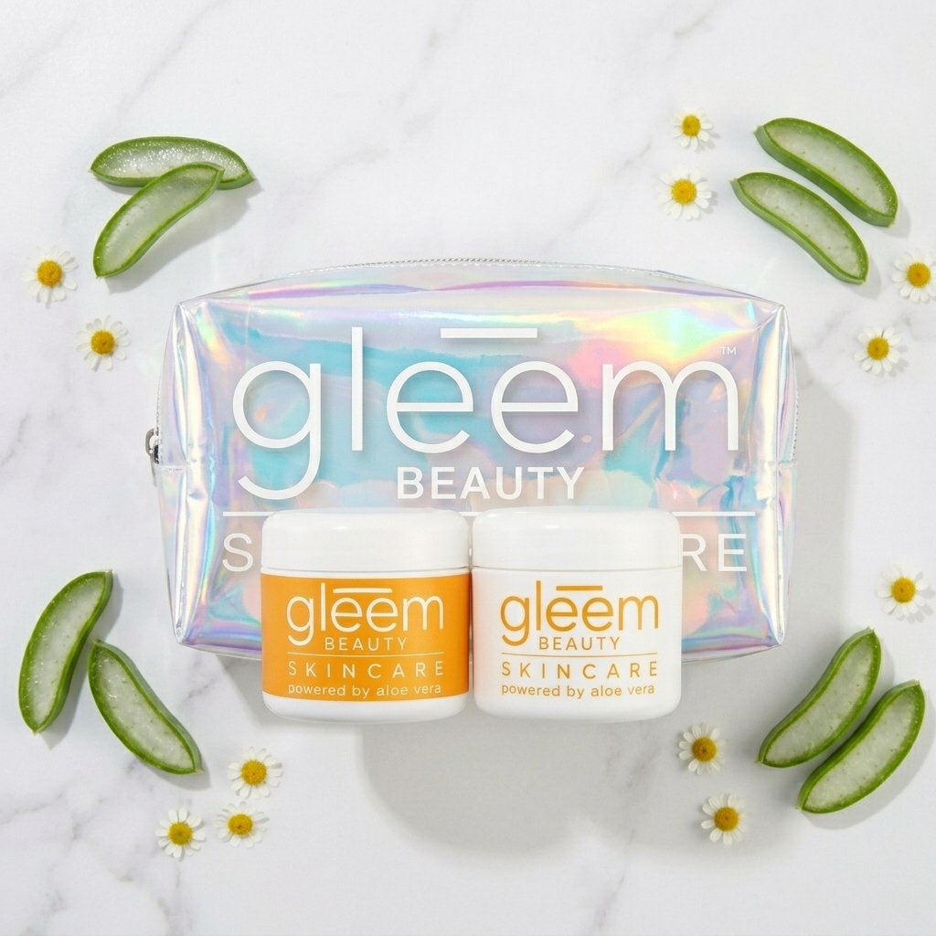 Gleem Beauty skincare set featuring an iridescent holographic zippered pouch and two white jars with orange labels, arranged on a white marble surface with aloe vera slices and daisies.